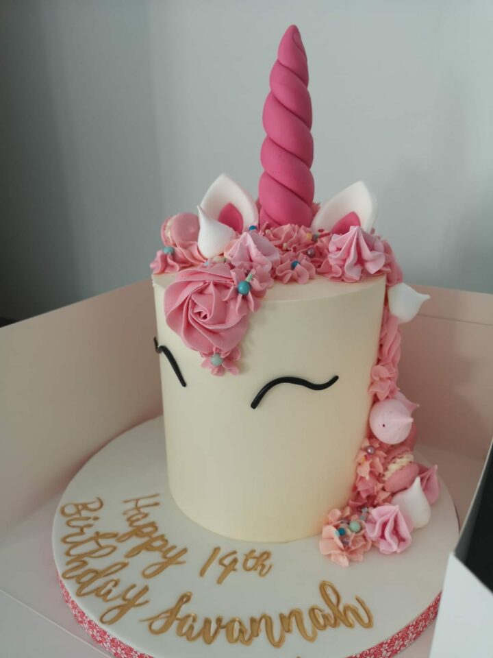 Beautiful and Cute Unicron cake with a pink tail and decorations
