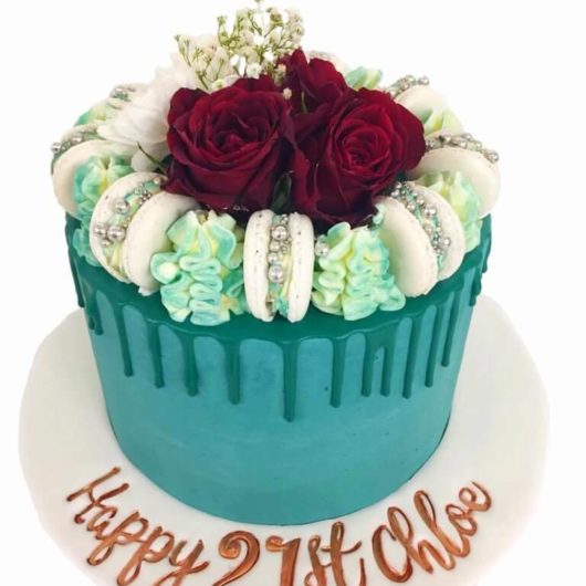 blue cream cake with red flowers