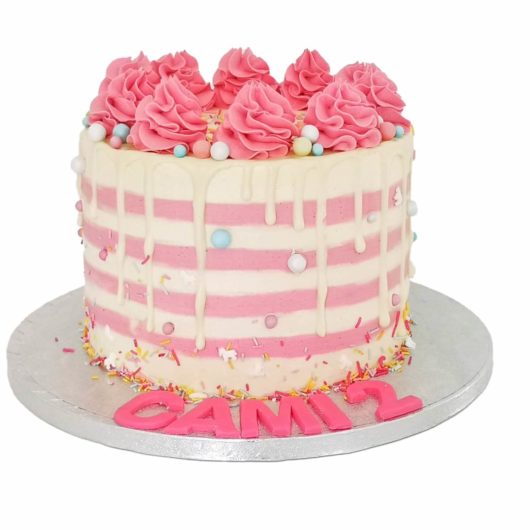 custom white cream cake with pink stripes and dots
