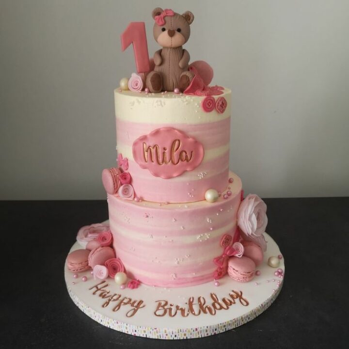 Pink teddy cake with buttons and macaroons